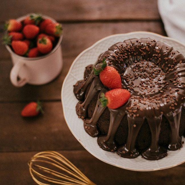 chocolate cake with strawberry on white ceramic plate