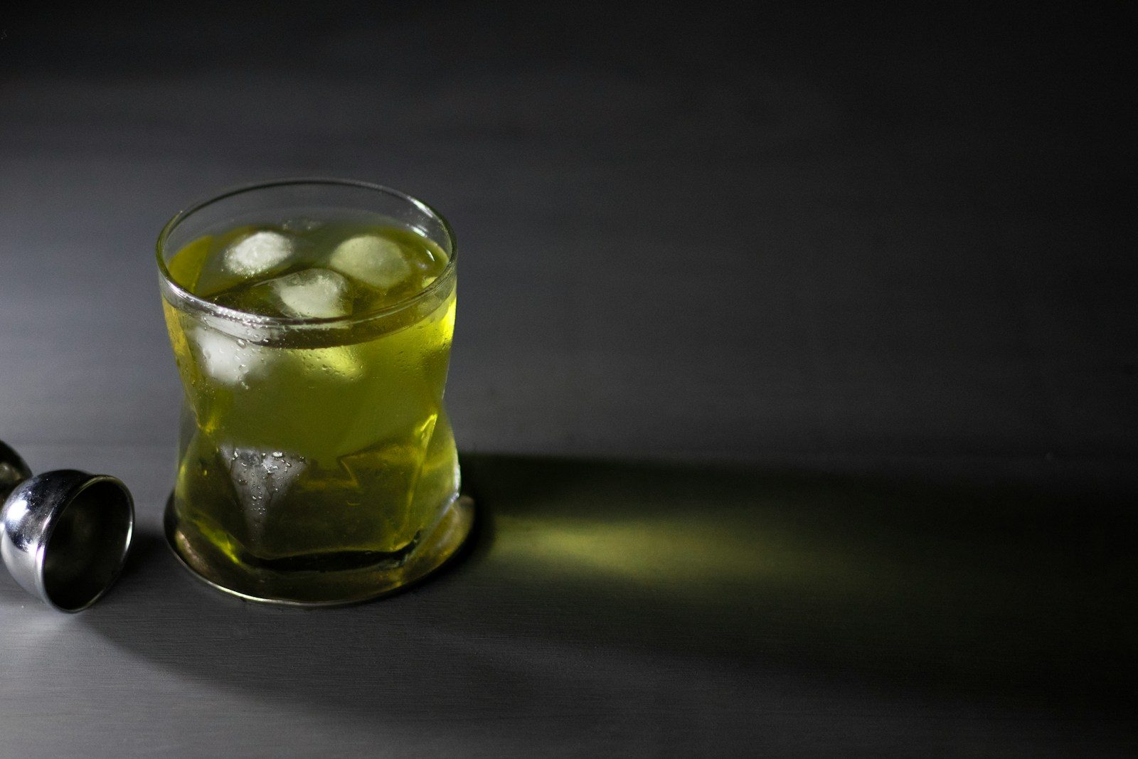 clear drinking glass with yellow liquid